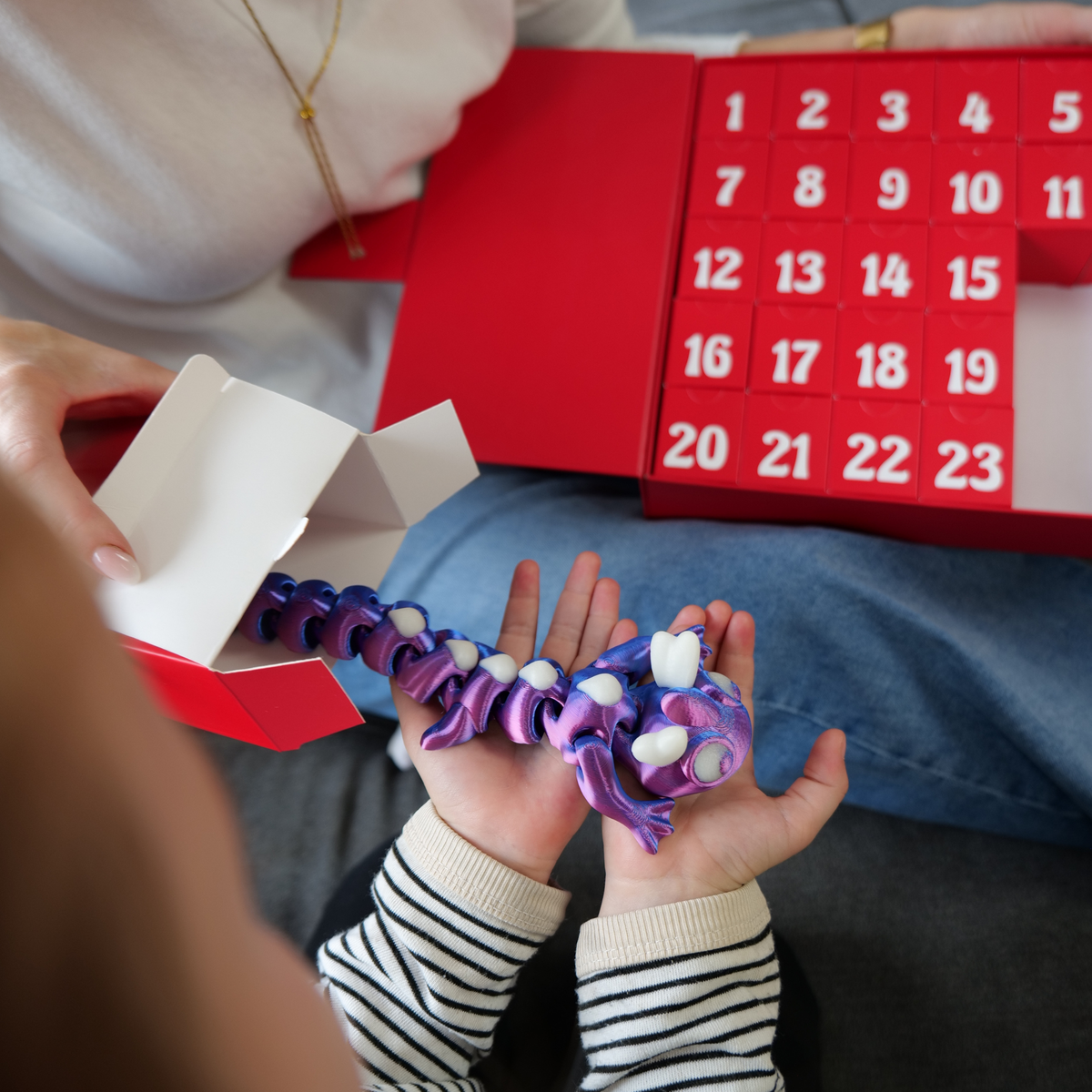 Wabbelz-Adventskalender-2026_05_Drache-Auspackmoment_Quadrat_v01